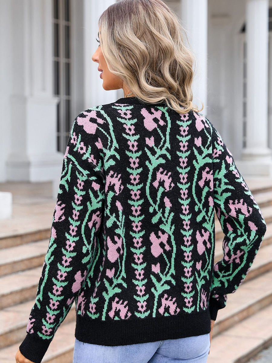 Black crewneck sweater with pink and green floral tapestry pattern, acrylic knit.