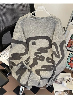 Gray oversized sweater with abstract dark gray pattern and ribbed hem.