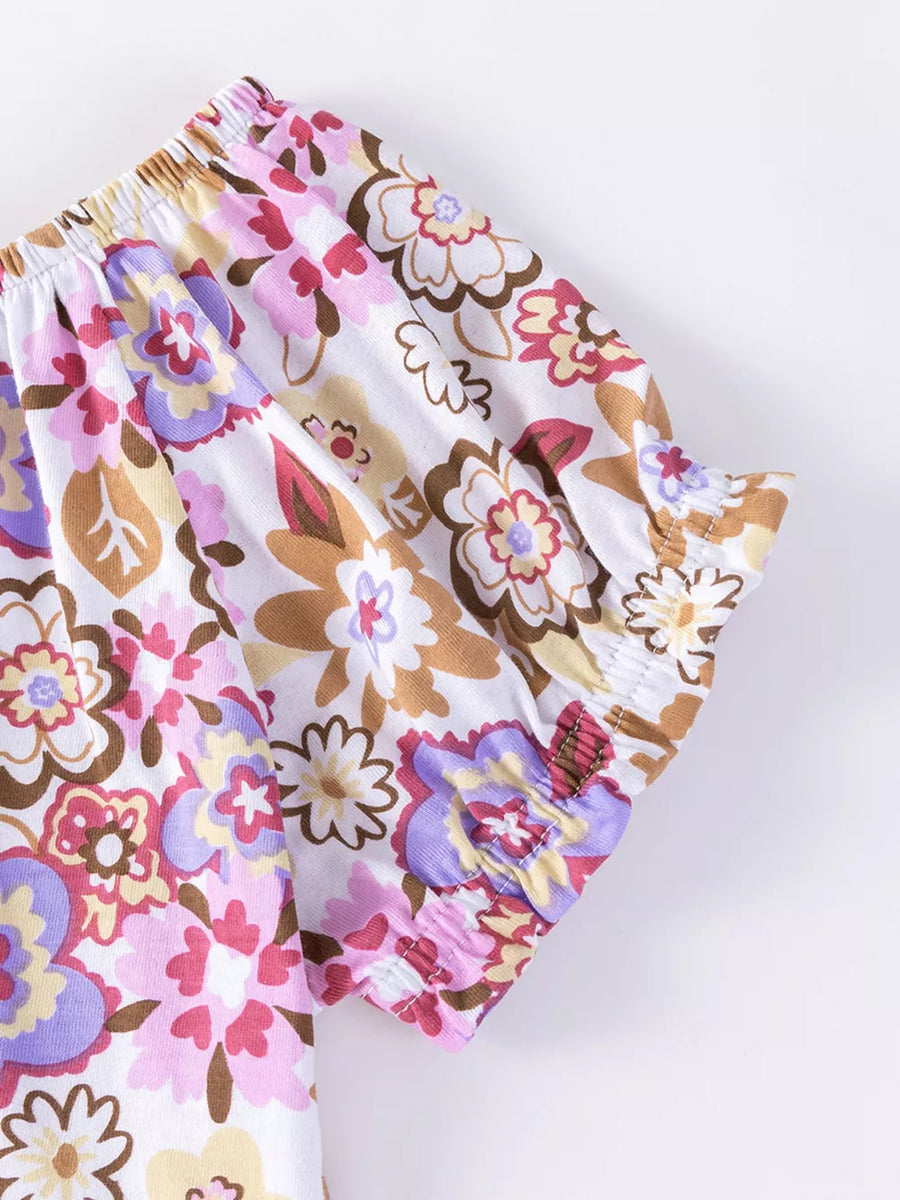 Girls' floral print cotton top with ruffled sleeves and elastic neckline.