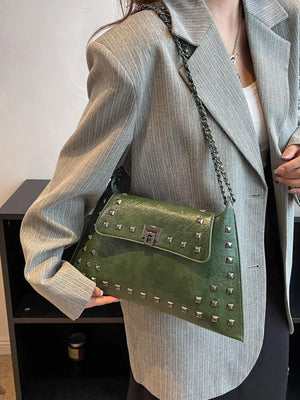 Green embellished chain flap shoulder bag with silver studs and lock closure.