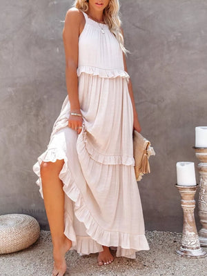White ruffled maxi dress with halter neckline and tiered skirt.