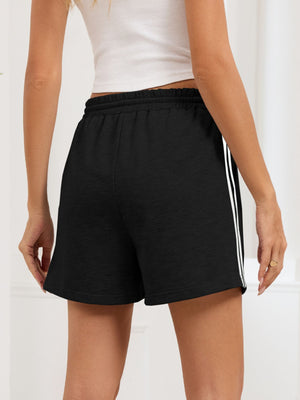 Black heathered jogger shorts with white side trim and drawstring waist.