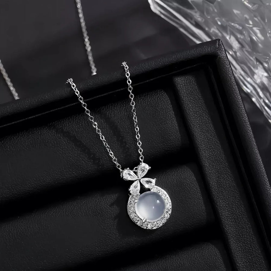 Sterling silver pendant necklace with round chalcedony and crystal accents.
