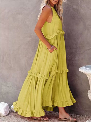 Yellow ruffled maxi dress with pockets and tiered skirt.