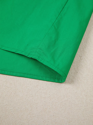 Green cotton blouse with ricrac trim detail and patchwork design.