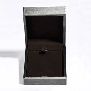 Open jewelry box with dark velvet lining and silver textured exterior.