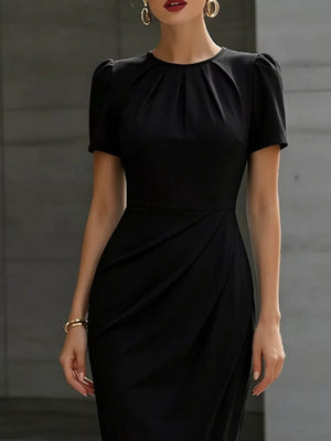 Black midi dress with ruched waist, pleated neckline and short puff sleeves.