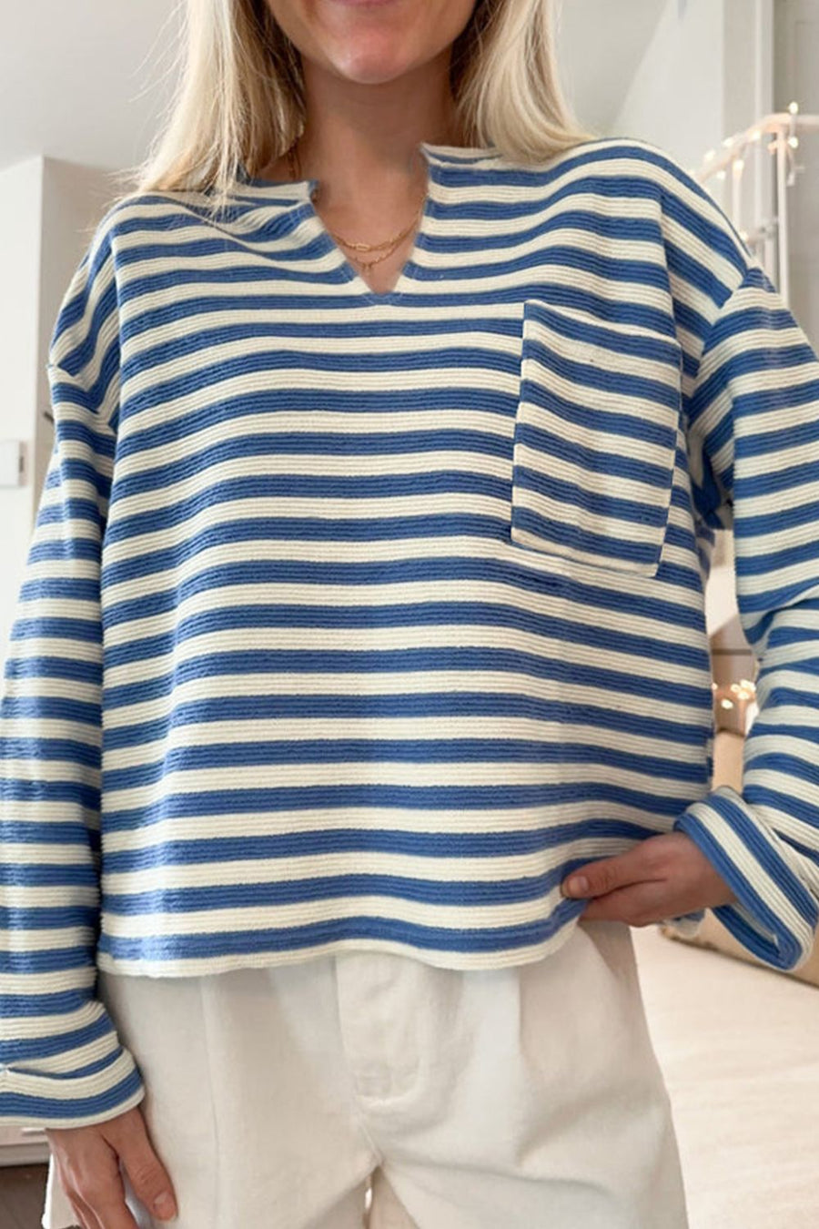 Peacock blue and white striped textured henley top with chest pocket and notch neckline.