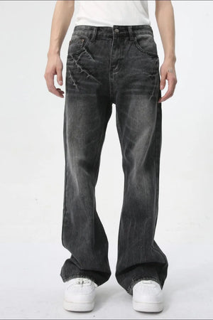 Washed black wide-leg denim jeans with a relaxed fit and distressed detailing.