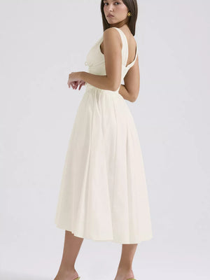Cream v-neck midi dress with gathered waist and a-line skirt.