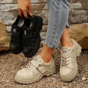 Beige and black lace up platform casual sneakers with chunky soles.