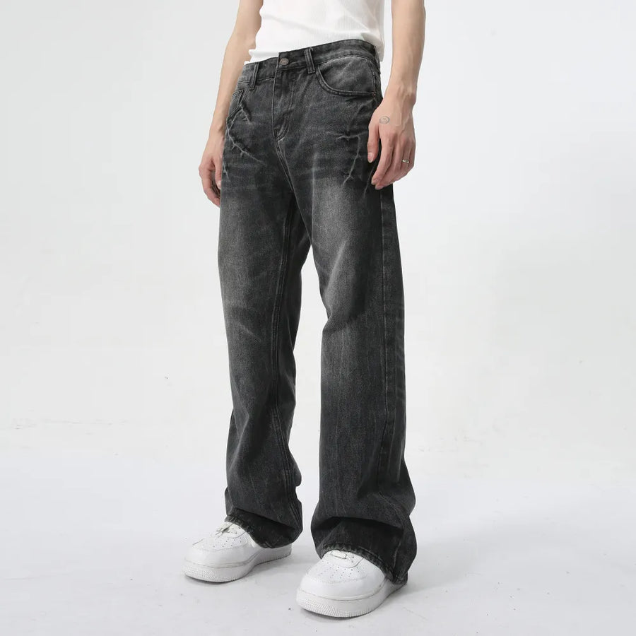 Washed black wide-leg denim jeans with a relaxed fit and subtle distressing.