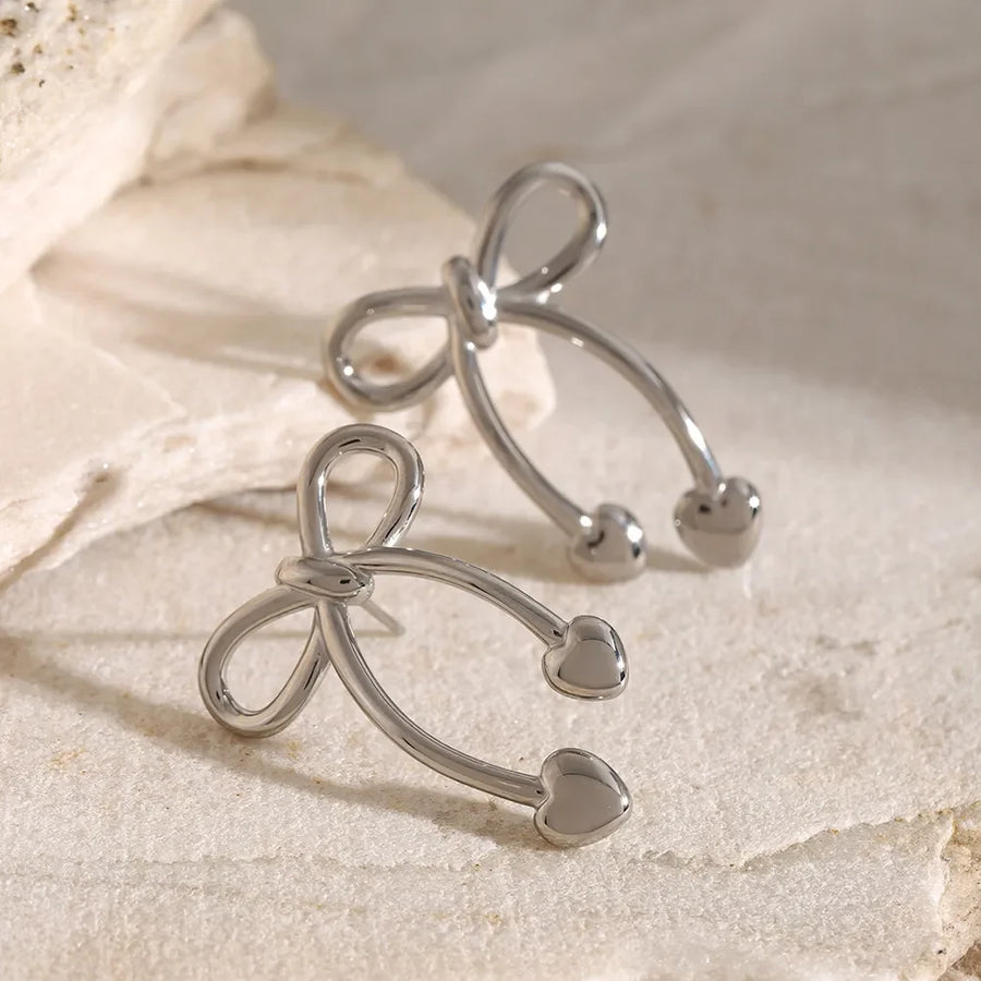 Silver bow drop earrings with heart tips