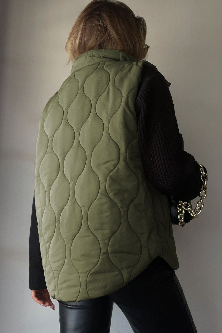 Quilted stand-collar gilet in Matcha Green with a wave pattern.