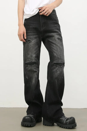 Distressed dark flare jeans with bleach wash and ripped details.