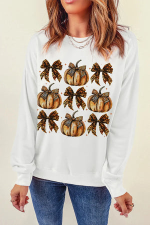 White crewneck sweatshirt with a graphic print of pumpkins adorned with leopard print bows.