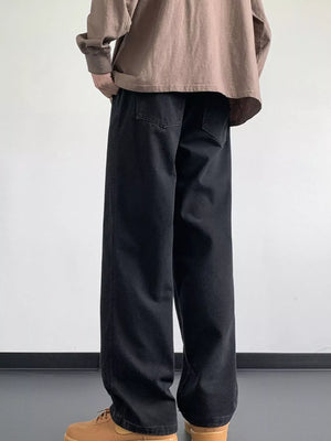 Black oversized drawstring jeans with a loose fit and back pockets.