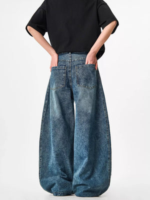 Blue acid-wash wide-leg jeans with a baggy fit and distressed texture.