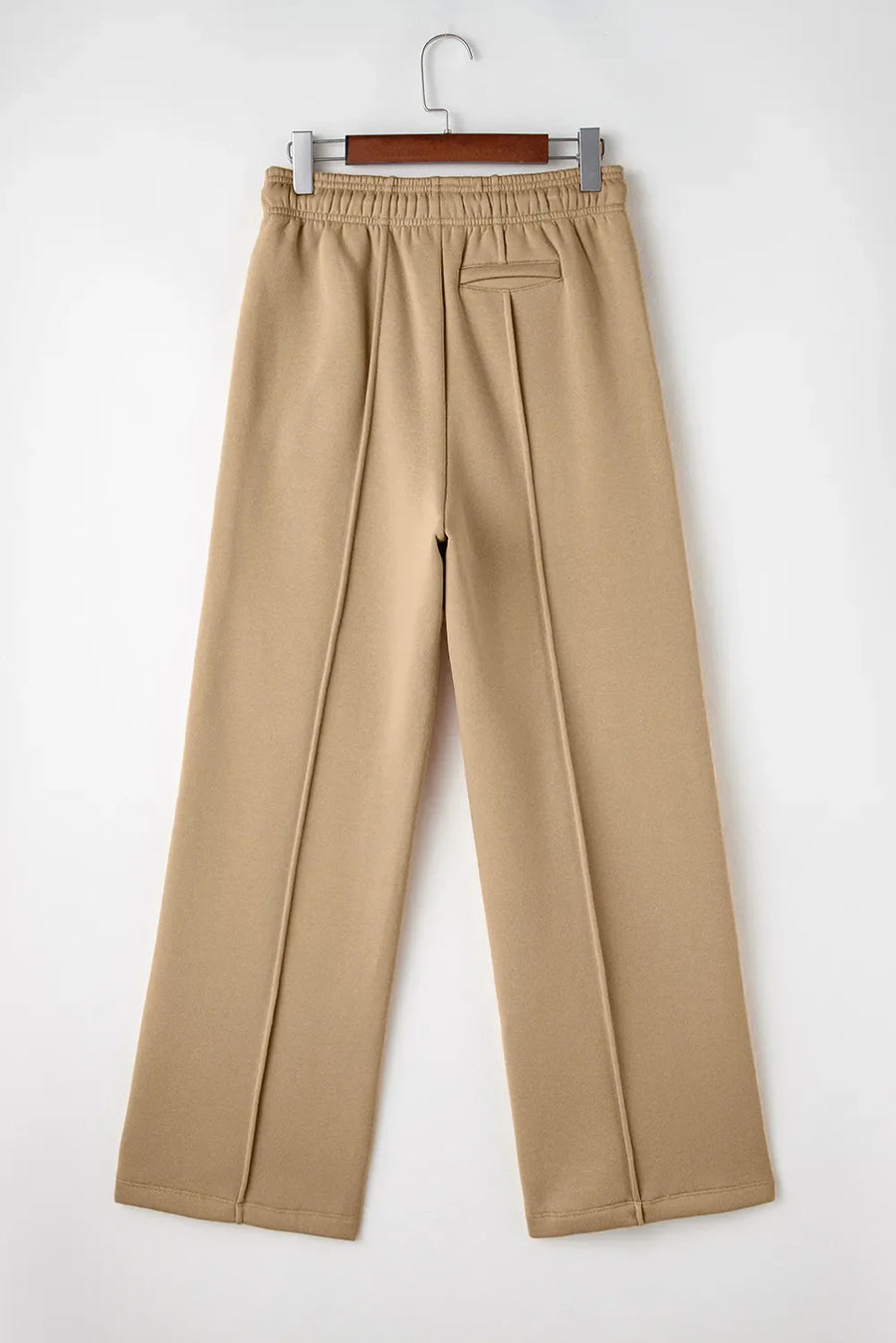 Tan wide-leg sweatpants with relaxed seam detail and elastic waistband.