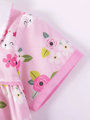 Pink cotton toddler dress with floral bunny print and ruffled collar.