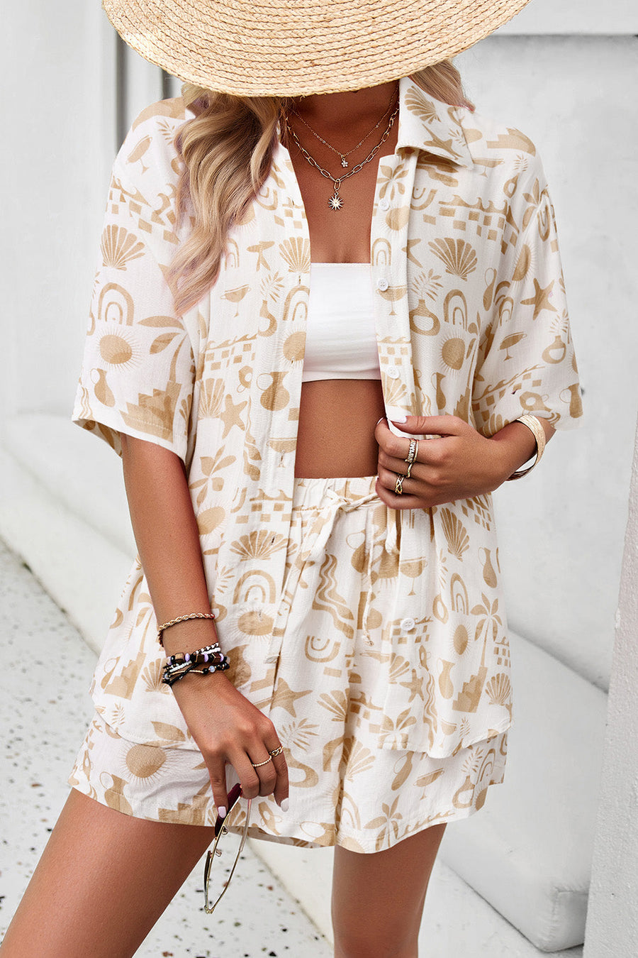 Women's resort shirt in tan abstract print, button-down with short sleeves, paired with matching shorts.