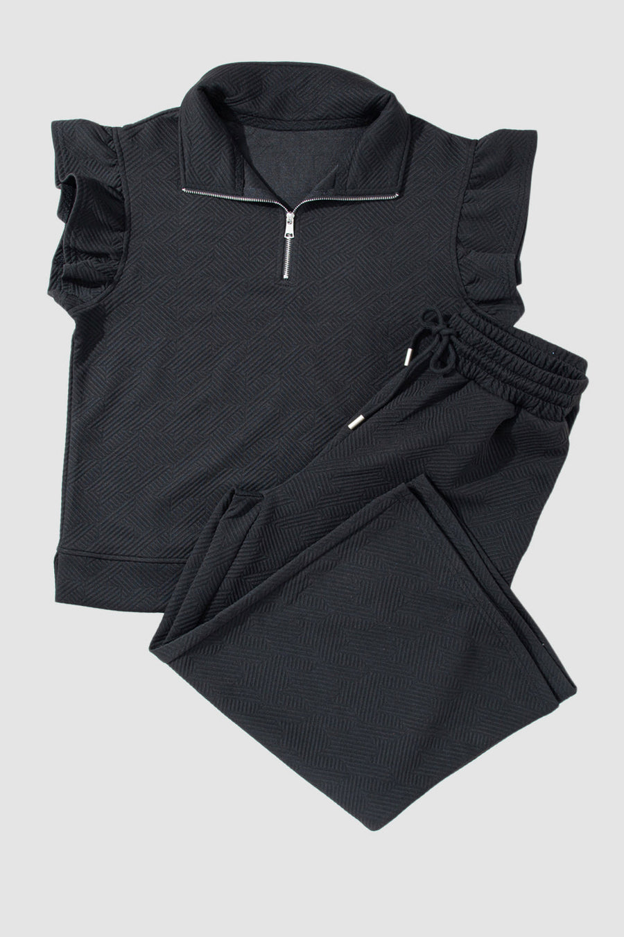 Black textured loungewear set with zip-up top and ruffle sleeves, and drawstring pants.