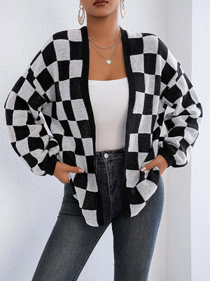 Checkerboard knit cardigan in black and white with balloon sleeves and open front.