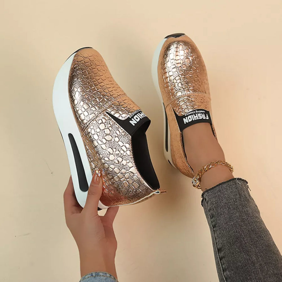 Gold metallic crocodile-embossed platform sneakers with chunky sole and black "FASHION" detail
