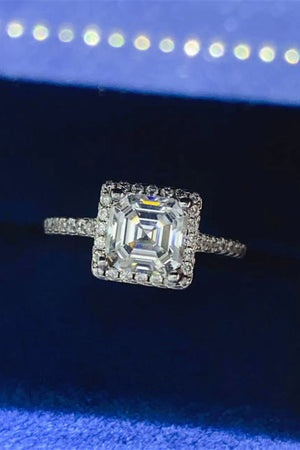 Silver halo ring with Asscher cut moissanite center stone and diamond band.