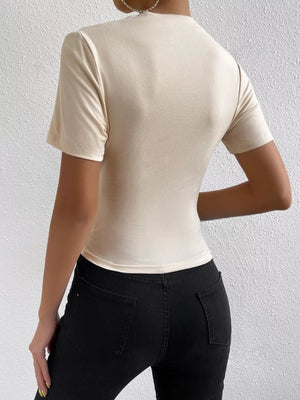 Apricot ruched t-shirt with mock neck and short sleeves, draped fit.