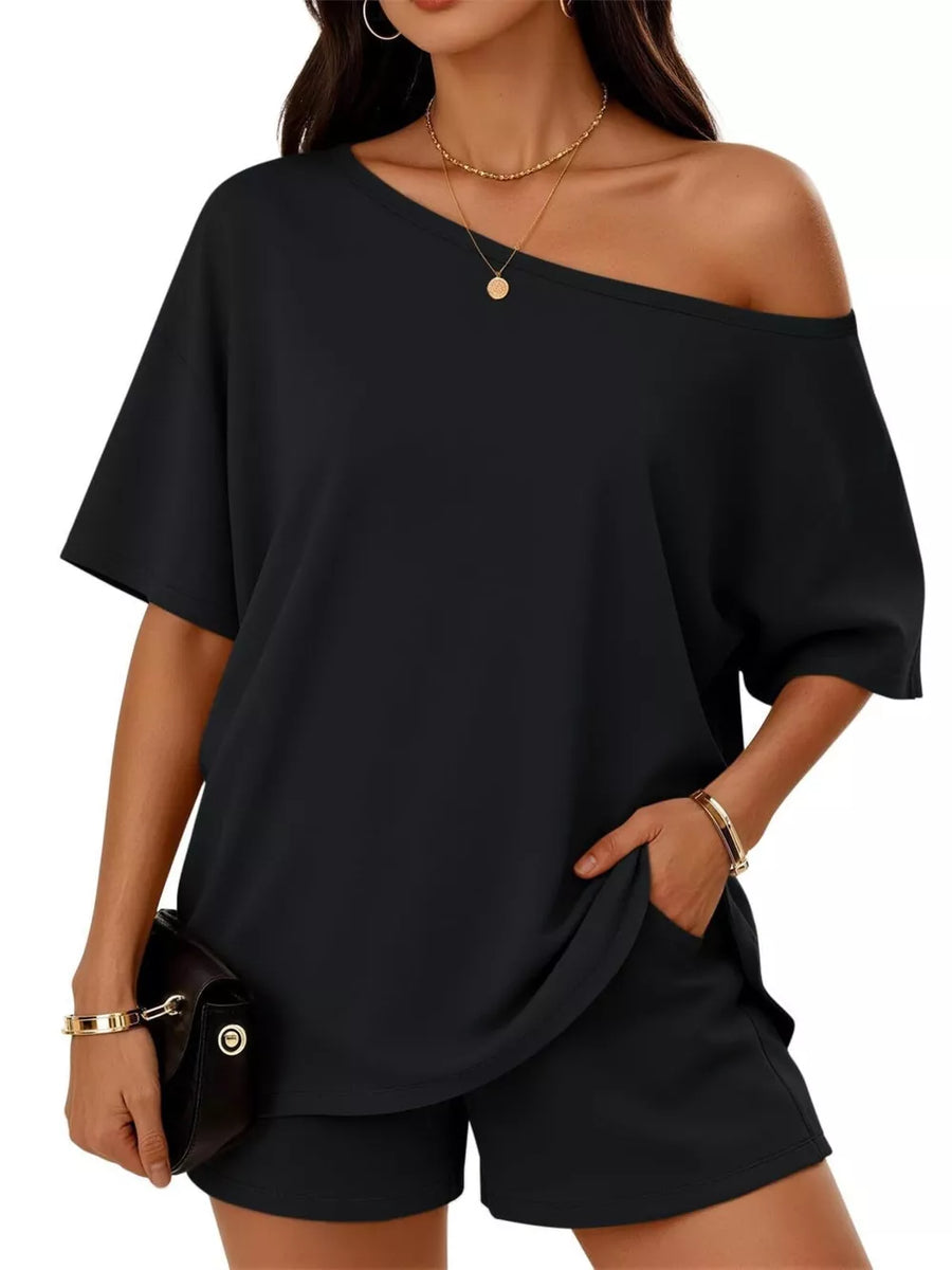Black boat neck tee and shorts set with off-the-shoulder styling and pockets.