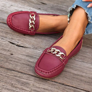 Chic burgundy round-toe loafers with gold chain detail.