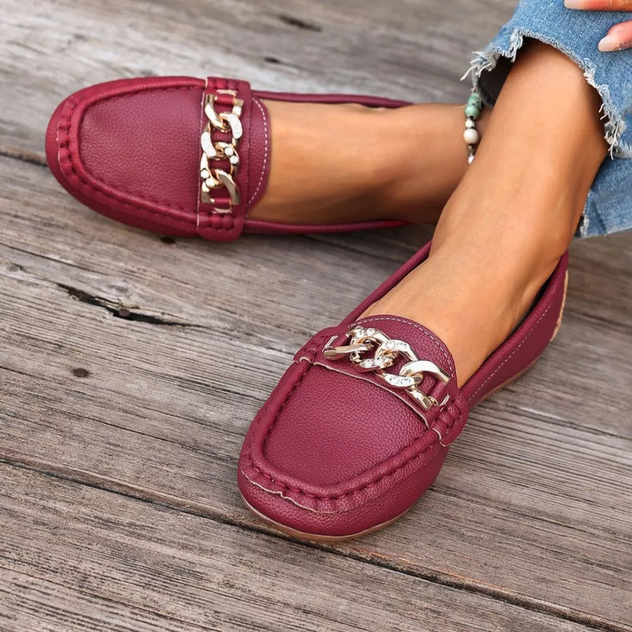 Chic burgundy round-toe loafers with gold chain detail.