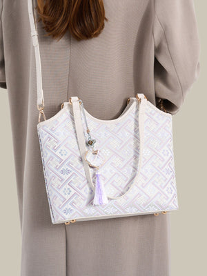 lavender shoulder bag featuring shoulder straps and geometric