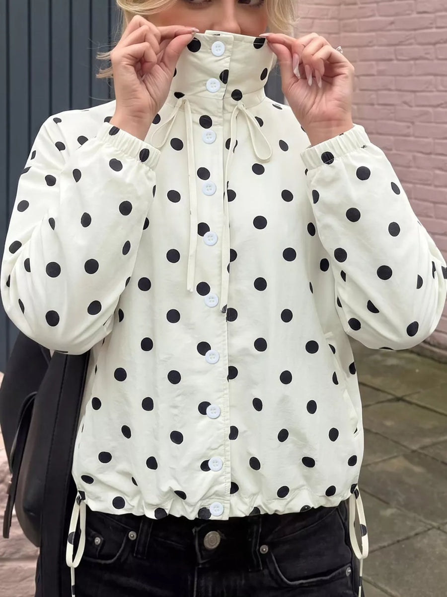 black windbreaker featuring buttoned and polka-dot