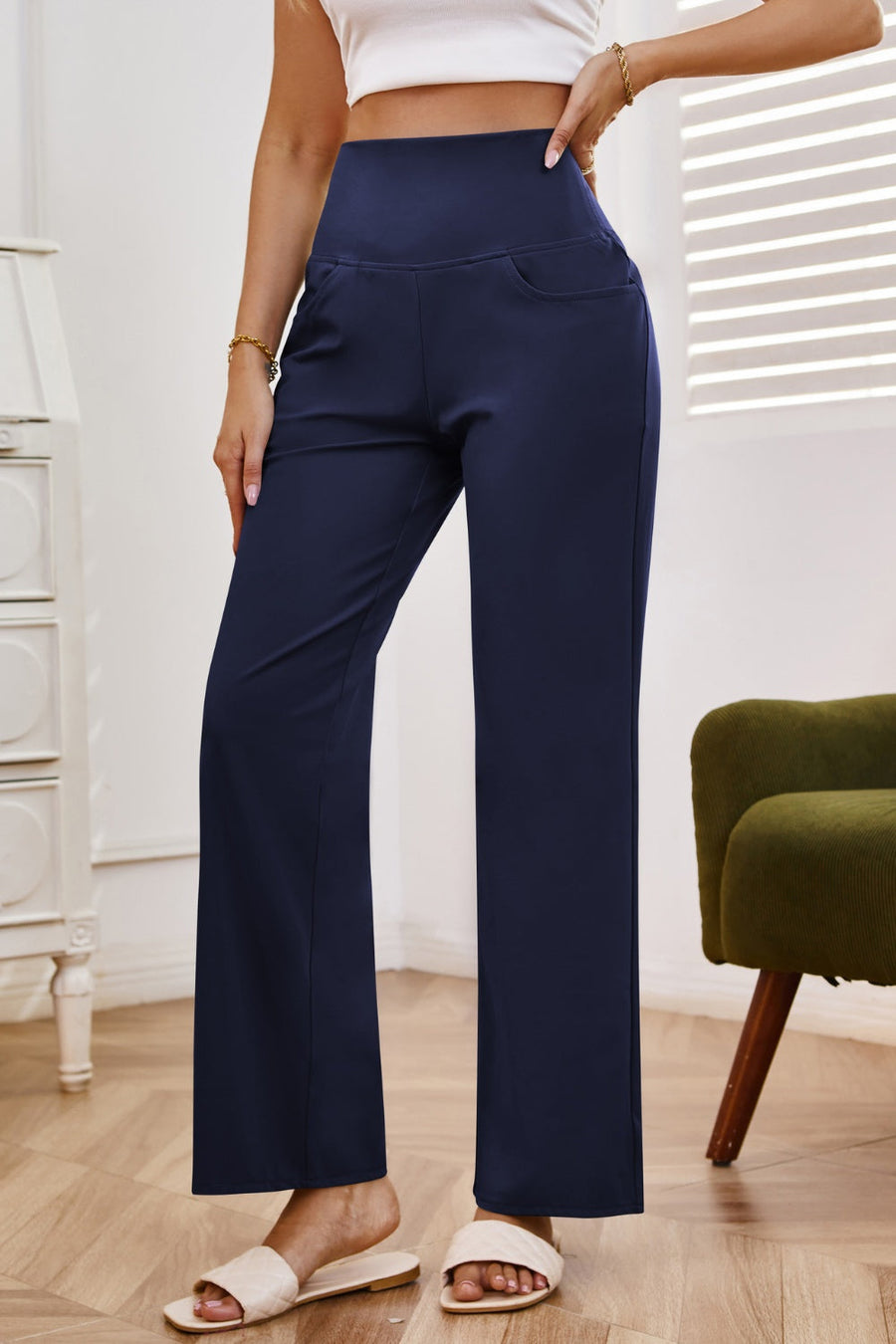 Navy high-waisted flare leg trousers with side pockets and a comfortable fit.
