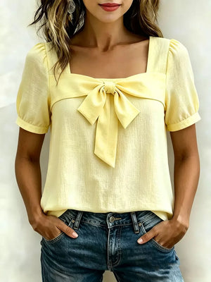 Yellow bow tie puff sleeve shirt with square neckline.