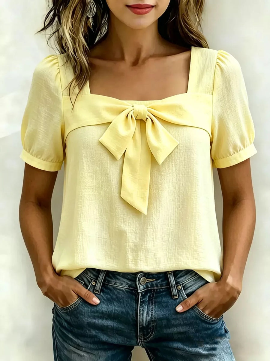 Yellow bow tie puff sleeve shirt with square neckline.