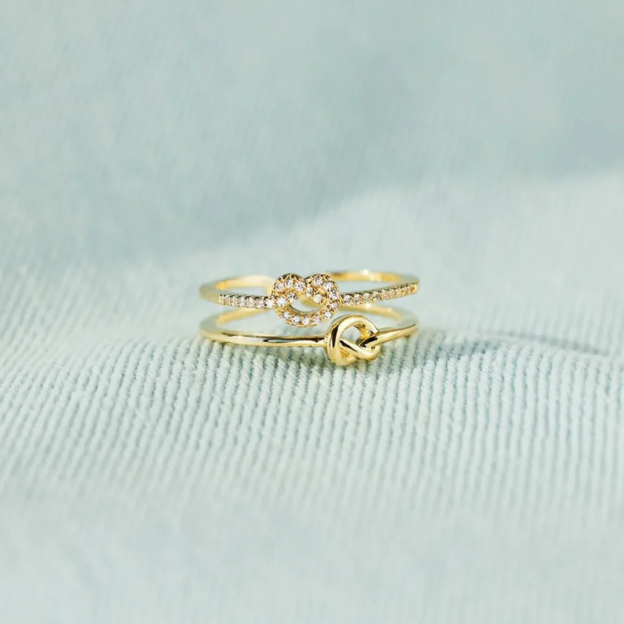 Gold knot rings, one with pavé detail, 18K gold-plated set