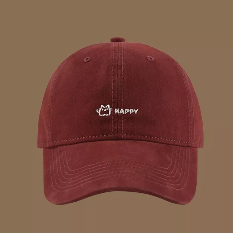 Wine red cotton baseball hat with embroidered cat and happy text detail.