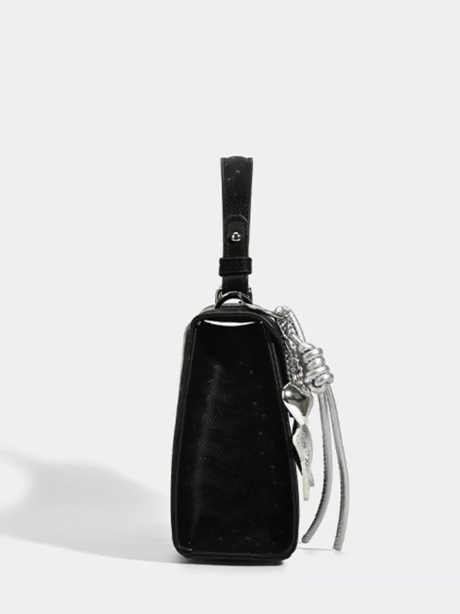 Black mini pu leather tote with embossed pattern and silver buckle detail.