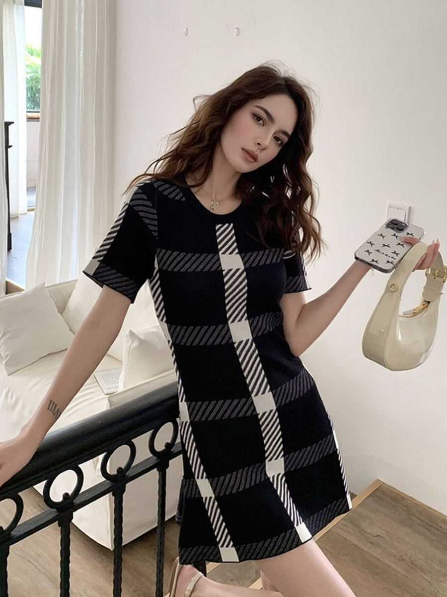 Black and white plaid mini dress with short sleeves and a round neckline.