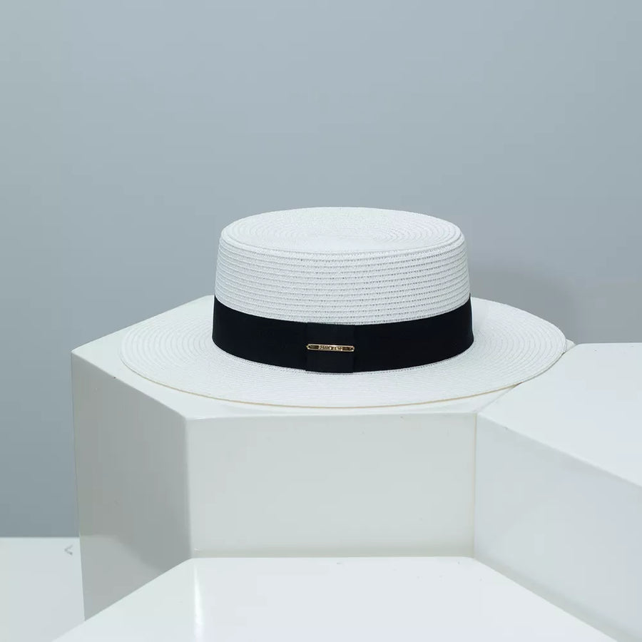 White straw boater hat with black band and gold detail