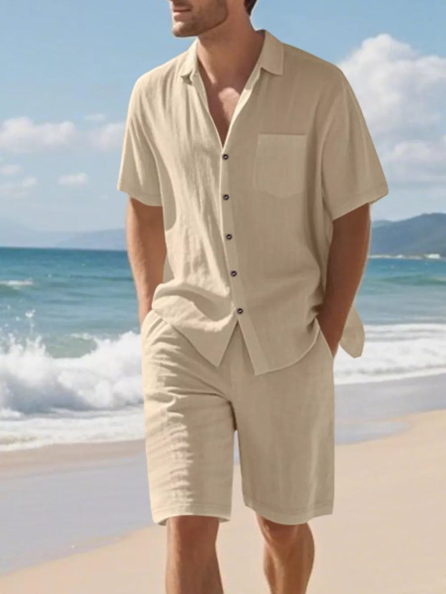 Men's Khaki short sleeve button-up shirt and shorts set on beach.