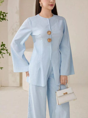 Light blue crinkled texture two-piece set with shell buttons and wide-leg pants.