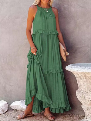 Green ruffled maxi dress with halter neck and tiered skirt.