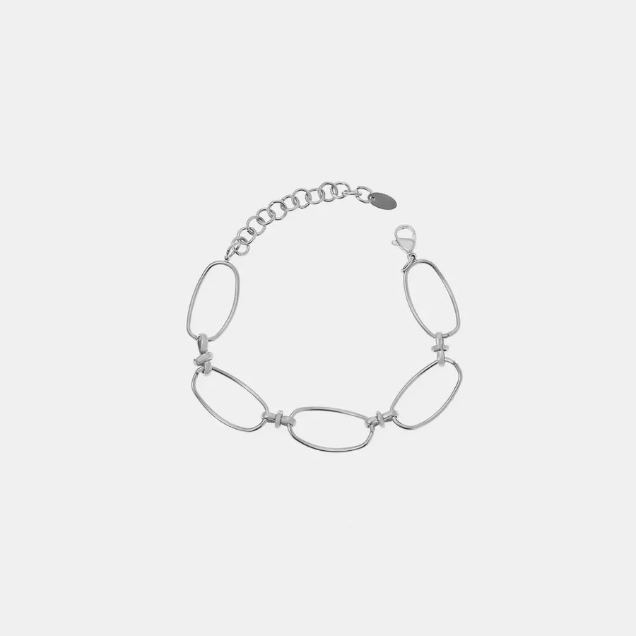 Silver elongated oval link bracelet with a textured chain extender and lobster clasp.