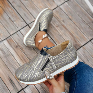 Grey and gold chevron print slip-on flats with a side zipper detail.