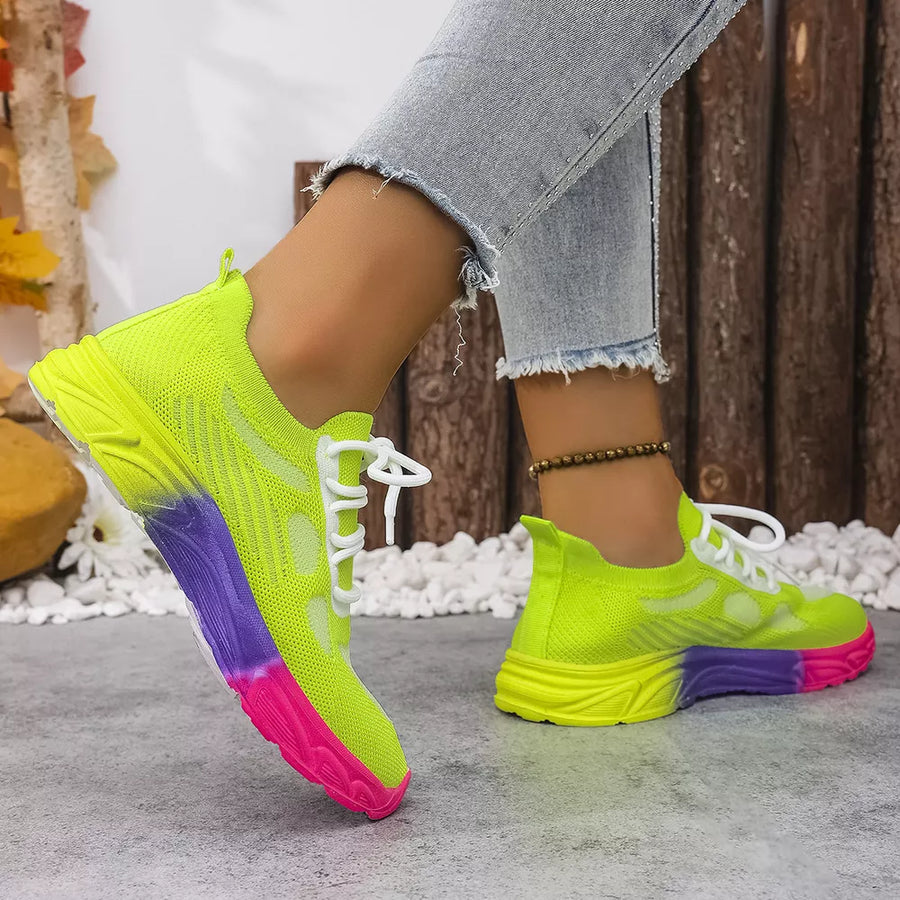 Breathable mesh lace-up sneakers in neon yellow with pink and purple sole detail.