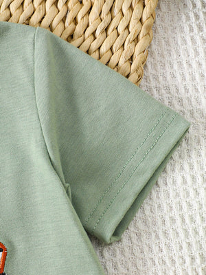 Light green cotton baby tee with embroidered tractor detail, short sleeves, crew neck.